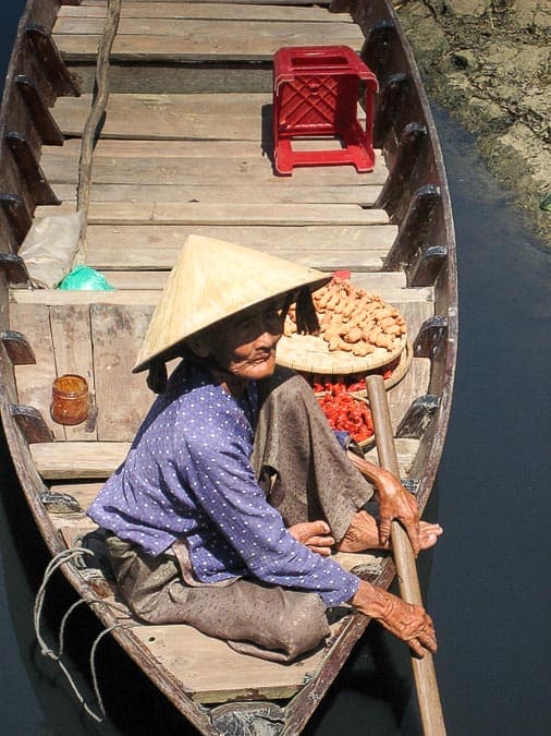 Vietnamese boat woman wearing non la hat