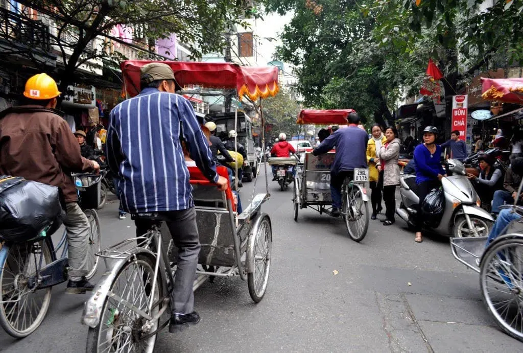 Cyclo tour in a busy Hanoi street