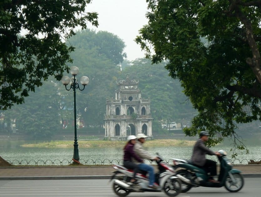 Scooters in Hanoi with Hoan Kiem Lake Pagoda in the background