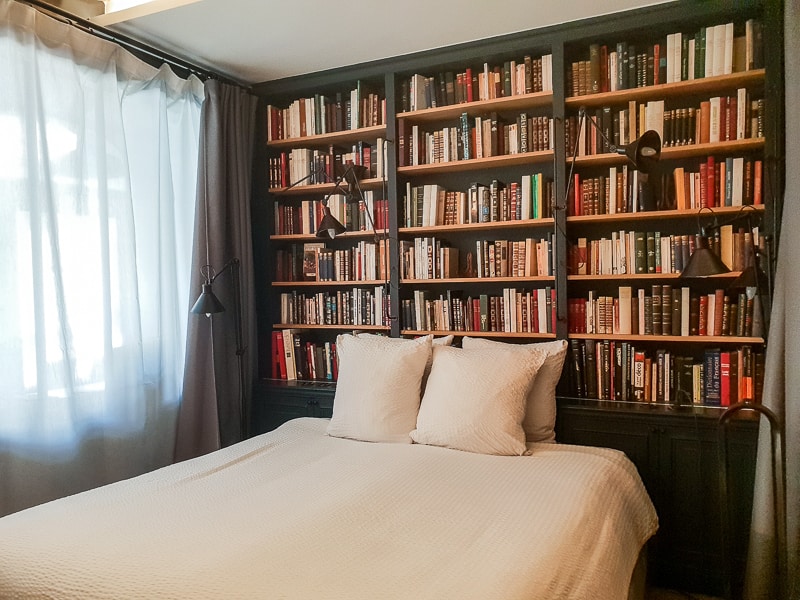 Bed with bookshelf behind