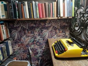 yellow typewriter and bookshelf