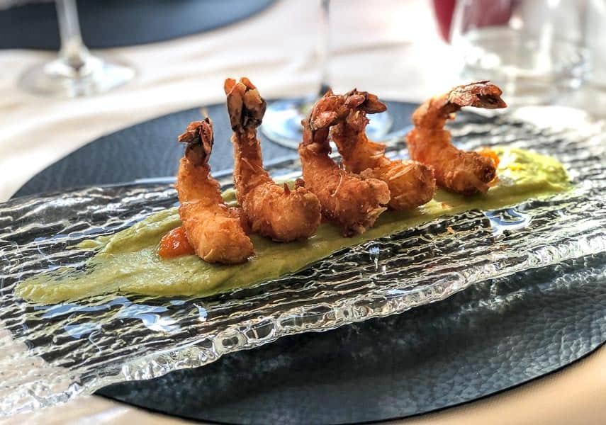almond crusted prawns served on a pumpkin, mustard and avocado puree