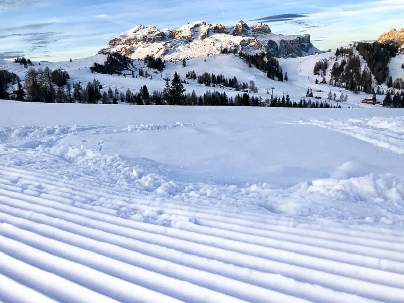 Groomed piste with mountain backdrop