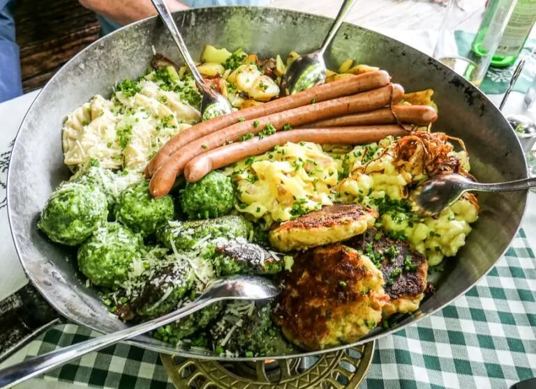 Austrian dumplings and sausages in frying pan