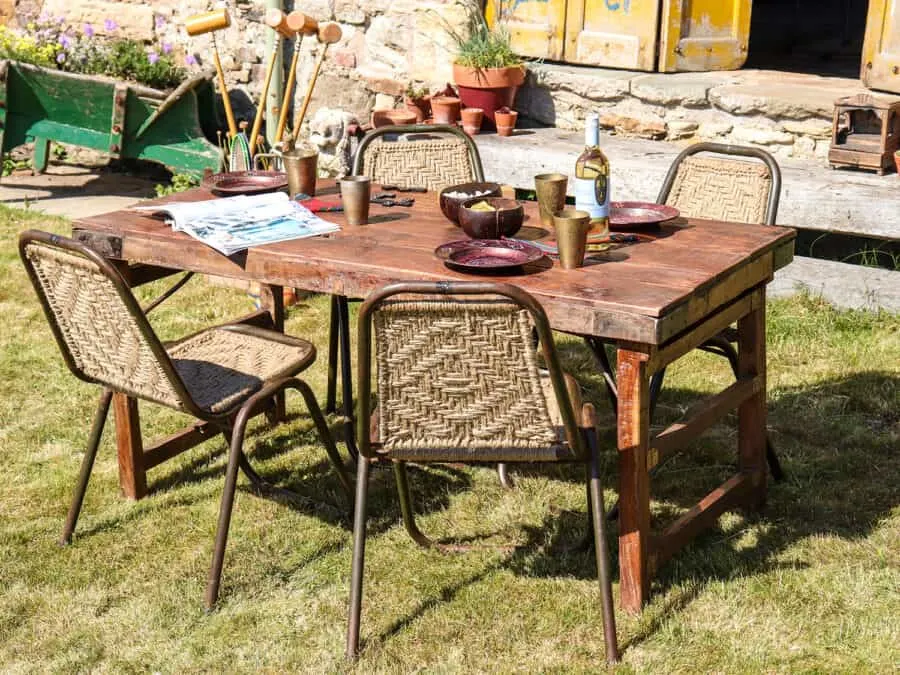 Recycled Furniture - wooden table and woven chairs in a garden setting