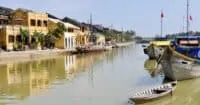 Thu Bon River, Hoi An with yellow houses reflecting on the water