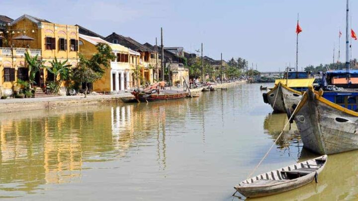 Thu Bon River, Hoi An with yellow houses reflecting on the water