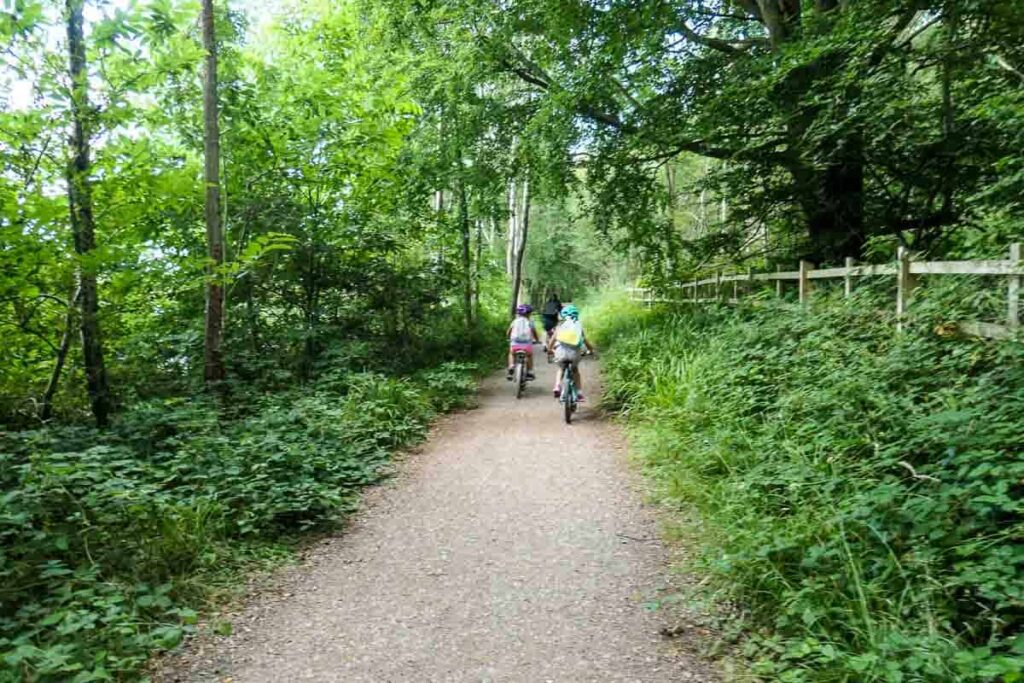 2 children cycling the Strawberry Line trail in Cheddar