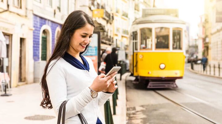 Data roaming in Europe - woman on mobile in Lisbon