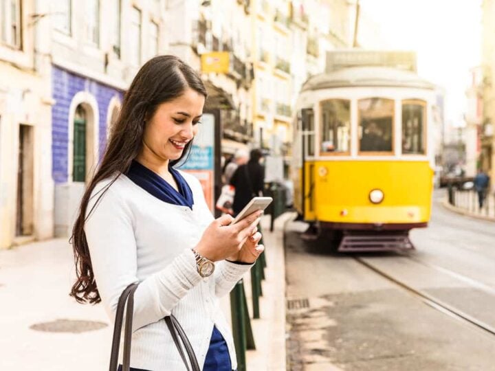 Data roaming in Europe - woman on mobile in Lisbon