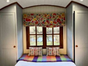 Colourful blind and cushions - shepherd hut interior