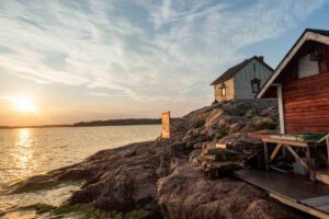 Turku Archipelago - wooden huts on small island at sunset