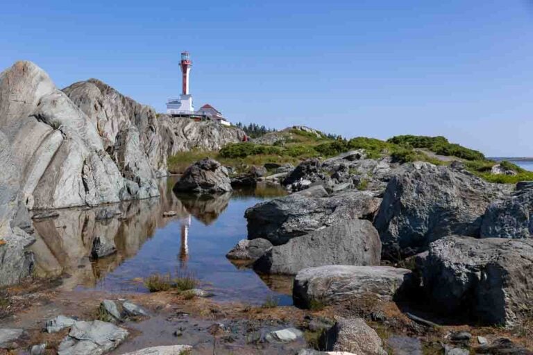 Cape Forchu Lighthouse reflected in rocky pool Nova Scotia