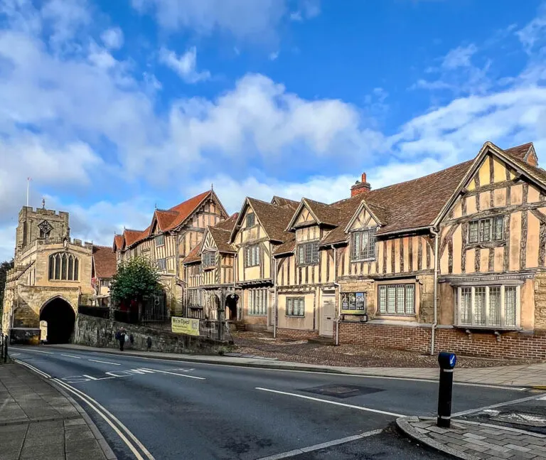 The Lord Leycester Hospital, one of the best things to do in Warwick. Half timbered building with archway and blue sky background