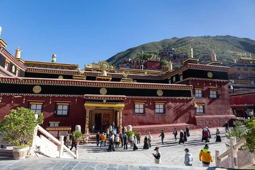 Looking down on Dege Parkhang Sutra-Printing House where people are walking past