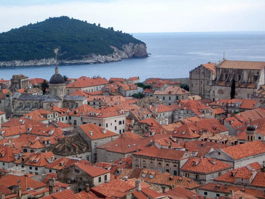 Looking over the red rooftops of Dubrovnik, Croatia with the sea and a wooded island in the background
