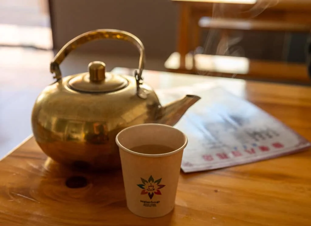 Traditional Chinese tea kettle and cup on a wooden table in Tibet.