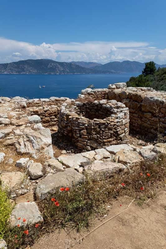 Historic stone ruins with Marmaris Bay in the background, Turkey.