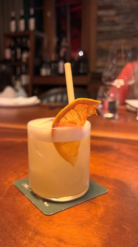 Velvet - a gin and grapefruit cocktail with a slice of dried orange to garnish