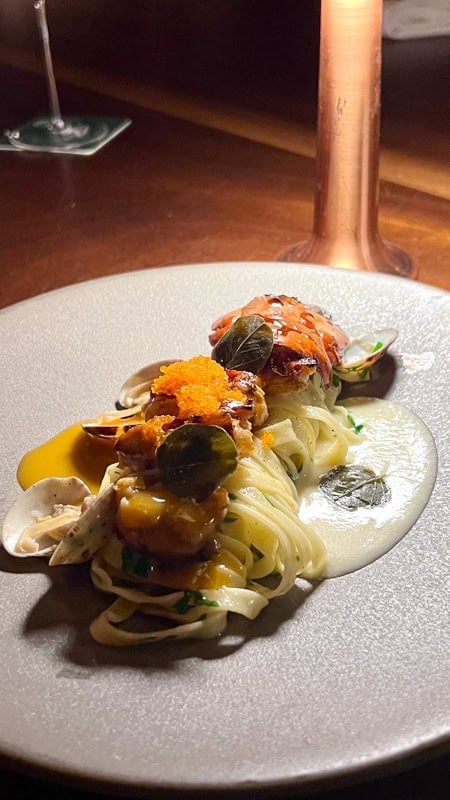 Pasta lobster dish with clams, roe and white sauce