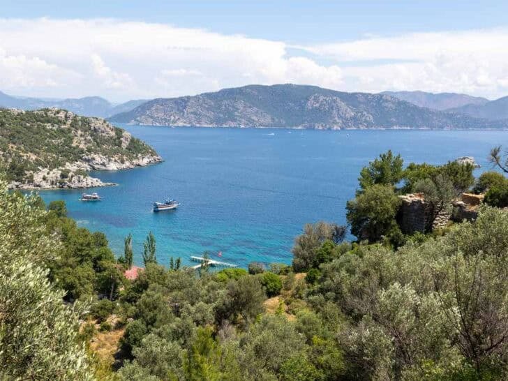 Views of Türkiye's turquoise coastal waters surrounded by pine-clad hills
